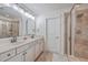 Bright bathroom featuring dual sinks, granite countertops, and a tiled walk-in shower at 2615 Rutherford Way, Charleston, SC 29414