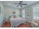 Serene bedroom with hardwood floors, ceiling fan, plantation shutters and decorative wreath at 2615 Rutherford Way, Charleston, SC 29414