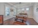 Bright dining room featuring wood floors, a modern light fixture, and a rustic wooden table and bench at 2615 Rutherford Way, Charleston, SC 29414