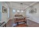 Elegant dining room with a rustic table, bench seating, and modern light fixture at 2615 Rutherford Way, Charleston, SC 29414