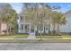 Two-story home with double porches, neat landscaping, and a walkway to the front door at 2615 Rutherford Way, Charleston, SC 29414
