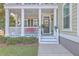 Inviting front porch with white railings, space for seating, and charming door with a wreath at 2615 Rutherford Way, Charleston, SC 29414