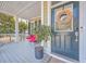 Cozy front porch with red cushioned seating, stylish decor, and charming front door at 2615 Rutherford Way, Charleston, SC 29414