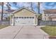 Close-up view of the two-car garage with carriage doors at 2615 Rutherford Way, Charleston, SC 29414