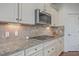 Well-equipped kitchen with stainless steel appliances, granite countertops, and custom tile backsplash at 2615 Rutherford Way, Charleston, SC 29414