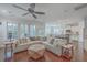 Bright living room with wood floors, a sectional sofa, and natural light streaming through shuttered windows at 2615 Rutherford Way, Charleston, SC 29414