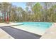 Large swimming pool surrounded by trees and lounge chairs provides relaxation and recreation at 2615 Rutherford Way, Charleston, SC 29414
