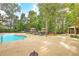 Large community pool with ample space for lounging and recreation amidst mature trees at 2615 Rutherford Way, Charleston, SC 29414