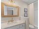 Bathroom featuring a marble vanity with gold accents, a decorative mirror and shower with curtain at 274 Alexandra Dr # 14, Mount Pleasant, SC 29464
