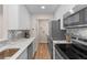 Compact kitchen with stainless appliances, marble counters, and ample storage space at 274 Alexandra Dr # 14, Mount Pleasant, SC 29464