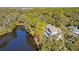 Aerial view of a home nestled among lush greenery and bordered by a tranquil pond at 31 Berkshire Hall, Kiawah Island, SC 29455