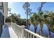 Enjoy this home's balcony view with stunning waterfront scenery, palm trees, and lush landscape at 31 Berkshire Hall, Kiawah Island, SC 29455