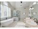 Bright bathroom with a large tub, glass shower, double vanity, and lots of natural light at 31 Berkshire Hall, Kiawah Island, SC 29455
