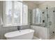 This bathroom features a freestanding tub, large window, and a glass-enclosed shower at 31 Berkshire Hall, Kiawah Island, SC 29455