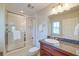 This bathroom features a tub-shower combo, granite countertop vanity, mirror, and modern fixtures at 31 Berkshire Hall, Kiawah Island, SC 29455