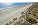 Serene beach aerial with a wooden walkway winding through the dunes, showcasing natural beauty and access at 31 Berkshire Hall, Kiawah Island, SC 29455