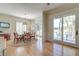 Open dining area featuring a round glass table, chairs, wainscoting and sliding door access to a deck overlooking the water at 31 Berkshire Hall, Kiawah Island, SC 29455