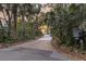 Paver driveway winding through lush trees leading up to the home at sunset at 31 Berkshire Hall, Kiawah Island, SC 29455