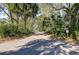Paver driveway leads through lush trees up to the home at 31 Berkshire Hall, Kiawah Island, SC 29455