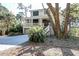 Exterior of the house with a porch, two car garage, and a stairway leading up to the front door at 31 Berkshire Hall, Kiawah Island, SC 29455