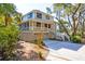 Exterior of house with a porch, two car garage, and a stairway leading up to the front door at 31 Berkshire Hall, Kiawah Island, SC 29455