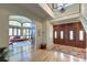 Grand foyer featuring wood floors, staircase, and an archway leading to the living room at 31 Berkshire Hall, Kiawah Island, SC 29455
