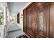 Ornate wood double front doors on a home with a covered porch and stylish lighting at 31 Berkshire Hall, Kiawah Island, SC 29455