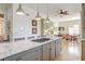 Open-concept kitchen featuring granite island with gas cooktop and an adjacent dining area at 31 Berkshire Hall, Kiawah Island, SC 29455