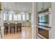 Bright kitchen boasts stainless appliances, granite countertops, tile backsplash, kitchen island with barstool seating and hardwood floors at 31 Berkshire Hall, Kiawah Island, SC 29455