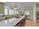 Spacious kitchen with stainless appliances, granite countertops, custom cabinets, central island with cooktop and barstool seating at 31 Berkshire Hall, Kiawah Island, SC 29455