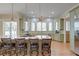 Bright, open kitchen featuring a granite island with seating and stainless steel appliances at 31 Berkshire Hall, Kiawah Island, SC 29455