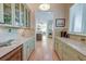 Well-lit kitchen with custom cabinets, granite countertops, and modern appliances at 31 Berkshire Hall, Kiawah Island, SC 29455