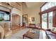 Bright living room with expansive windows, stylish seating, and easy access to outdoor space at 31 Berkshire Hall, Kiawah Island, SC 29455