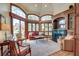 Cozy living room featuring large windows, a fireplace, and comfortable seating at 31 Berkshire Hall, Kiawah Island, SC 29455
