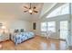 This main bedroom features vaulted ceiling, large window, ceiling fan, and balcony access at 31 Berkshire Hall, Kiawah Island, SC 29455