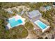 Aerial view featuring multiple pools, lush greenery, and nearby buildings at 31 Berkshire Hall, Kiawah Island, SC 29455