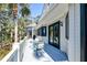 Exterior view of a covered porch with outdoor seating, overlooking the surrounding landscape and adjacent to the house at 31 Berkshire Hall, Kiawah Island, SC 29455