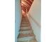 Unfinished wood staircase with a handrail against a white wall, leading to another level at 31 Berkshire Hall, Kiawah Island, SC 29455