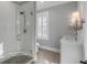 Bathroom featuring a glass shower, tiled floors and walls, a window with shuttered blinds, and a vanity at 3699 Goodwater St, Mount Pleasant, SC 29466