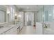 Gorgeous bathroom boasts marble floors, double sinks, a glass enclosed shower, and tub at 3699 Goodwater St, Mount Pleasant, SC 29466