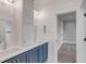 Bathroom featuring double sinks with modern fixtures, blue cabinets, and a doorway into an adjacent room at 3699 Goodwater St, Mount Pleasant, SC 29466