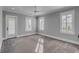 Bedroom featuring grey walls, carpet, a ceiling fan, and a door and windows with shuttered blinds at 3699 Goodwater St, Mount Pleasant, SC 29466
