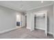Carpeted bedroom with a walk-in closet and ensuite bathroom, illuminated by recessed lighting at 3699 Goodwater St, Mount Pleasant, SC 29466