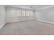 Spacious bedroom with classic wainscoting, ceiling fan, and large windows with shutter blinds at 3699 Goodwater St, Mount Pleasant, SC 29466