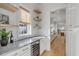 Butler pantry featuring granite countertops, wine fridge, and storage, with open view to the kitchen at 3699 Goodwater St, Mount Pleasant, SC 29466