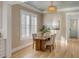 Dining room with wood table, seating for four, and elegant light fixture with lots of natural light at 3699 Goodwater St, Mount Pleasant, SC 29466