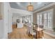 Open floor plan, with dining area and kitchen island. The dining area has a wood table and seating for four at 3699 Goodwater St, Mount Pleasant, SC 29466