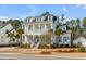 Elegant two-story home with a classic design, featuring a welcoming front porch and beautiful landscaping at 3699 Goodwater St, Mount Pleasant, SC 29466