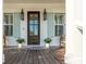 Charming front entrance featuring a wood door, light blue shutters, and decorative lanterns at 3699 Goodwater St, Mount Pleasant, SC 29466