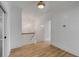 Open hallway showcasing gleaming hardwood floors and bright shiplap walls, illuminated by modern lighting at 3699 Goodwater St, Mount Pleasant, SC 29466